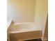 Close up of a clean white bathtub with chrome fixtures, next to a window seat at 13039 Peacock Ln, Charlotte, NC 28215