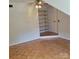 View of a bedroom featuring parquet flooring, storage shelves, and ceiling fan at 13039 Peacock Ln, Charlotte, NC 28215