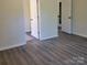 Bedroom featuring wood-look floors, neutral walls, and white trim near doorways at 13039 Peacock Ln, Charlotte, NC 28215