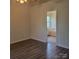 Bedroom features wood-look floors and ensuite bathroom with a tub at 13039 Peacock Ln, Charlotte, NC 28215