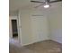 A carpeted bedroom with neutral colors has ample closet space at 13039 Peacock Ln, Charlotte, NC 28215