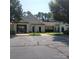 Exterior view of a community clubhouse with a parking lot in front at 13039 Peacock Ln, Charlotte, NC 28215