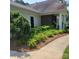 Landscaped path leading to the clubhouse entrance, showcasing colorful flower beds and greenery at 13039 Peacock Ln, Charlotte, NC 28215