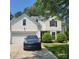 Charming two-story home with a garage, landscaped yard, and a well-maintained driveway at 13039 Peacock Ln, Charlotte, NC 28215
