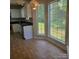 Bright kitchen eat-in area with tile flooring and natural light from the window to the backyard at 13039 Peacock Ln, Charlotte, NC 28215