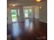 Open floor plan with hardwood floors, a fireplace, and natural light that floods in through the windows at 13039 Peacock Ln, Charlotte, NC 28215