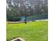 Community playground with slide surrounded by a lush green lawn and mature trees at 13039 Peacock Ln, Charlotte, NC 28215