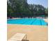 Community swimming pool with multiple lanes and lounge chairs for residents at 13039 Peacock Ln, Charlotte, NC 28215
