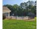Beautiful community pool surrounded by secure fencing and lush landscaping at 13039 Peacock Ln, Charlotte, NC 28215