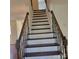 A beautiful staircase has stained handrails and banisters ready to take you to the second floor at 13039 Peacock Ln, Charlotte, NC 28215