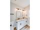 Bathroom with double granite vanity, white cabinets, and bronze fixtures at 1407 7Th St # 4, Statesville, NC 28677