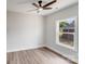 Well-lit bedroom with hardwood floors, modern ceiling fan, and a large window at 1407 7Th St # 4, Statesville, NC 28677