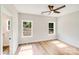 Bedroom with neutral walls, two windows, ceiling fan, and wood-look flooring at 1407 7Th St # 4, Statesville, NC 28677
