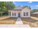 Charming white home with a welcoming front porch and well-manicured lawn under a bright blue sky at 1407 7Th St # 4, Statesville, NC 28677