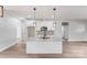 Open kitchen with white cabinets, granite counters, and stainless microwave at 1407 7Th St # 4, Statesville, NC 28677
