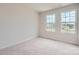 Bright bedroom with plush carpeting and natural light coming in from two windows at 146 Astor St, Troutman, NC 28166
