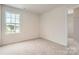 Cozy bedroom with plush carpeting, a window overlooking the yard, and access to a walk-in closet at 146 Astor St, Troutman, NC 28166