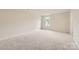 Spacious bedroom with neutral carpet and ample natural light from a centrally placed window at 146 Astor St, Troutman, NC 28166