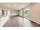 Bright living area with wood floors, sliding glass doors, and kitchen island, perfect for entertaining at 146 Astor St, Troutman, NC 28166
