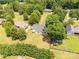 Expansive backyard with patio seating area, surrounded by a privacy fence and mature trees at 1530 Danlee Dr, Lancaster, SC 29720