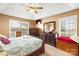 Comfortable bedroom with a ceiling fan, ample natural light, and dark wood furnishings at 1530 Danlee Dr, Lancaster, SC 29720