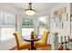 Cozy breakfast nook with bright windows, a round table, and plush yellow chairs at 1530 Danlee Dr, Lancaster, SC 29720