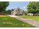 Attractive home featuring manicured lawn and a long drive leading to a side-entry garage at 1530 Danlee Dr, Lancaster, SC 29720