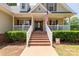 Welcoming front porch with brick steps and white railing, featuring seasonal decorations at 1530 Danlee Dr, Lancaster, SC 29720