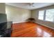 Bedroom with hardwood floors, a ceiling fan, neutral walls, and bright natural light at 156 Spruce St, Badin, NC 28009