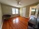 Bedroom showcasing wood floors, a ceiling fan, and a connected hallway at 156 Spruce St, Badin, NC 28009