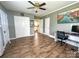 Versatile room with neutral paint, laminate flooring, closet, and an open doorway, can be used as an office at 156 Spruce St, Badin, NC 28009