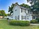 Well-maintained two-story home showcasing clean white siding and well-maintained landscaping on the large front yard at 156 Spruce St, Badin, NC 28009