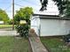 Garage featuring white siding, a concrete walkway, and a fenced entrance at 156 Spruce St, Badin, NC 28009