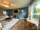 Spacious living room with a stone feature wall, comfortable seating, and large window for natural light, cozy atmosphere at 156 Spruce St, Badin, NC 28009