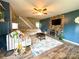 Comfortable living room features a stone accent wall, plush sectional sofa, and stylish decor with modern flooring at 156 Spruce St, Badin, NC 28009
