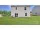 View of backyard and rear exterior with sliding glass doors and lush lawn at 157 Astor St, Troutman, NC 28166