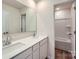 Bright bathroom featuring double vanity, modern fixtures, and tub shower at 157 Astor St, Troutman, NC 28166
