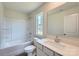 Sparkling white bathroom featuring a bathtub, and sink with a large mirror at 157 Astor St, Troutman, NC 28166