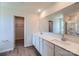 Bathroom featuring double sinks, white cabinets, quartz countertops, and wood floors at 157 Astor St, Troutman, NC 28166