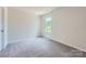 Bedroom with carpeted floors, a window, and white walls at 157 Astor St, Troutman, NC 28166