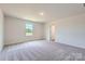 Bright bedroom with carpeted floors, a window, and a white door at 157 Astor St, Troutman, NC 28166