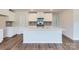 Modern kitchen with stainless steel appliances, gray backsplash, and an island with a white countertop at 157 Astor St, Troutman, NC 28166
