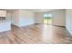 Bright living room with hardwood floors, a sliding glass door, and white walls at 157 Astor St, Troutman, NC 28166