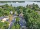 Aerial view showcases a beautiful neighborhood near a lake and abundant trees at 15708 Eagleview Dr, Charlotte, NC 28278