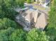 Aerial view of the home showcasing the outdoor living space, rear deck, and lush tree surround at 15708 Eagleview Dr, Charlotte, NC 28278