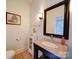 Charming powder room with granite countertop, framed mirror, and painted wall at 15708 Eagleview Dr, Charlotte, NC 28278