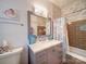 Well-lit bathroom features a marble vanity, tiled wall accents, and modern fixtures at 15708 Eagleview Dr, Charlotte, NC 28278