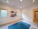 Minimalist room featuring three large windows, an organized display, and neutral carpet at 15708 Eagleview Dr, Charlotte, NC 28278