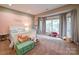 Comfortable bedroom with a large window, and a cozy decor including plush toys at 15708 Eagleview Dr, Charlotte, NC 28278