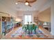 Upstairs bonus room features hardwood floors, natural light, and ceiling fan at 15708 Eagleview Dr, Charlotte, NC 28278